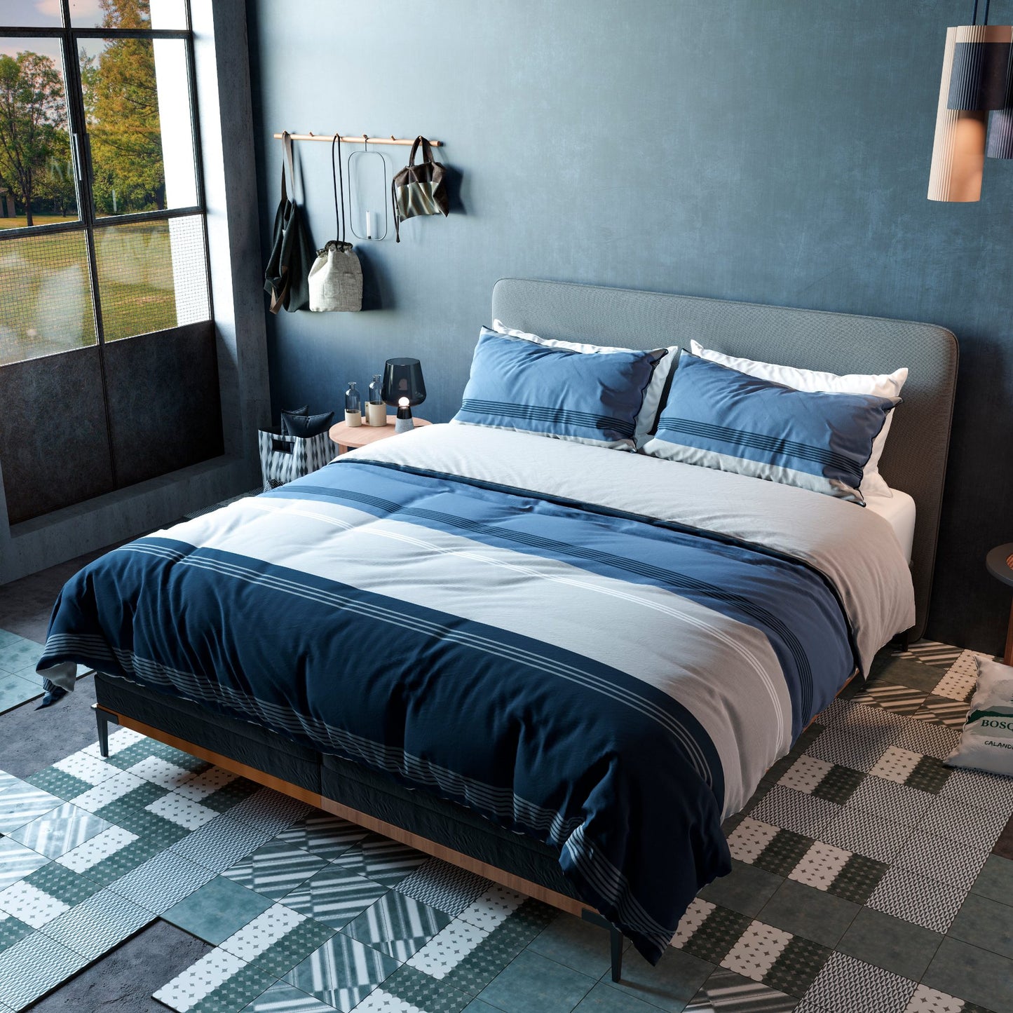 Edredón Índigo tendido en cama con almohadas a juego