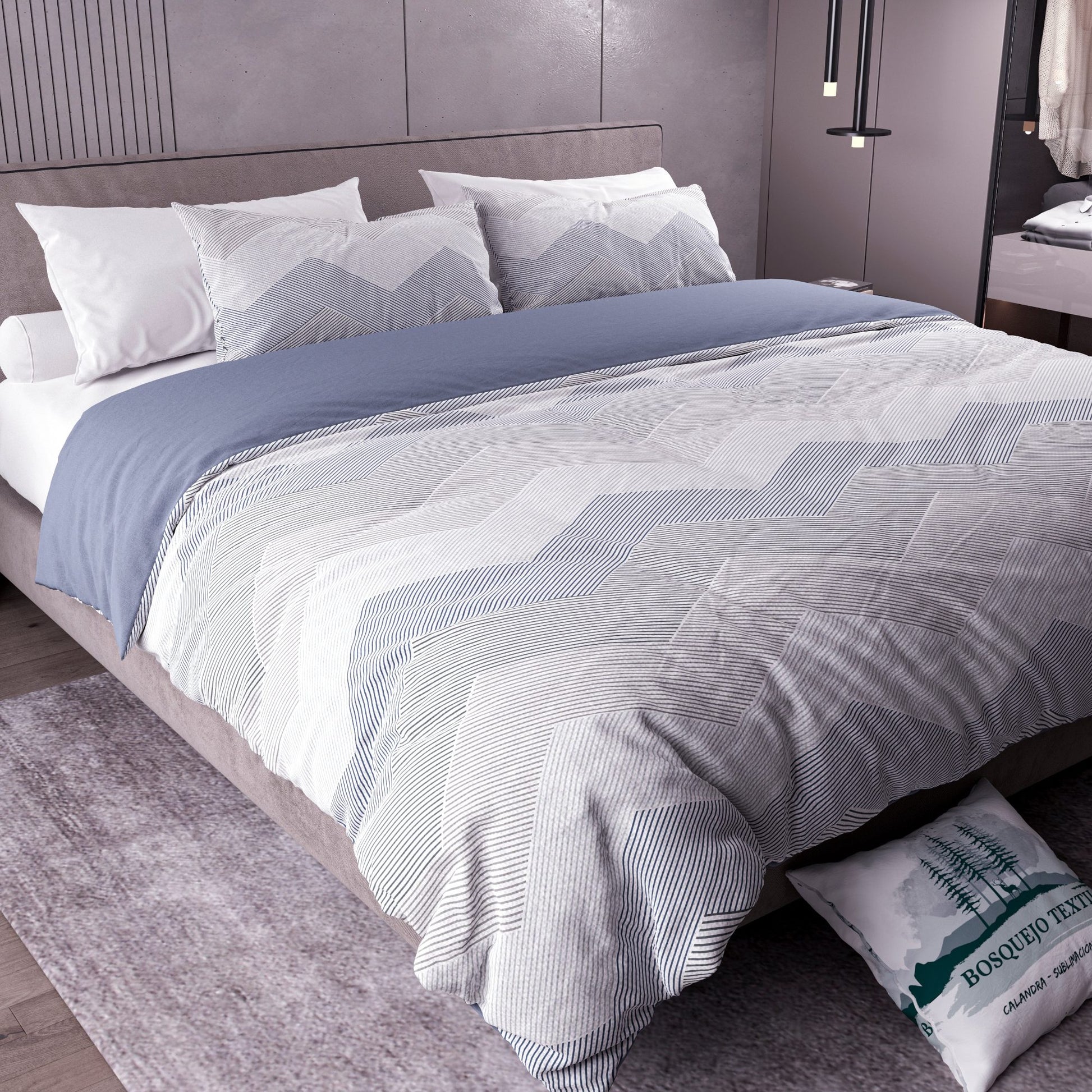 Edredón Oslo tendido en cama con almohadas a juego